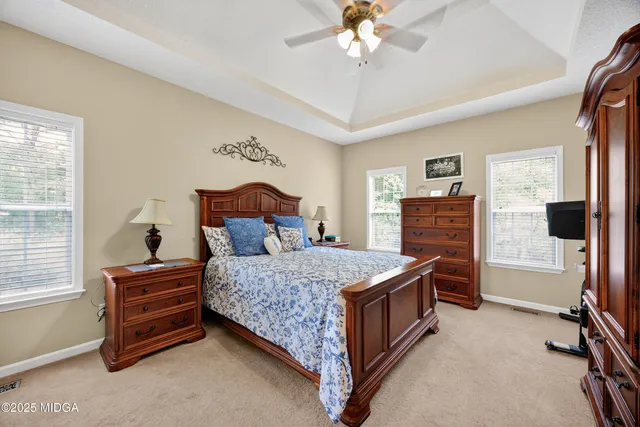 a bedroom with a bed and dresser