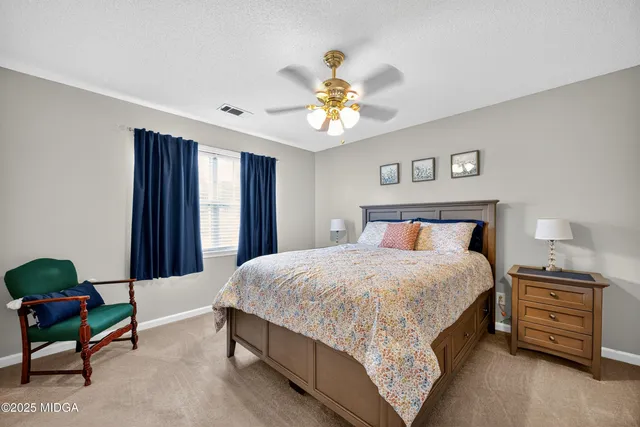 a bedroom with a bed dresser and a window