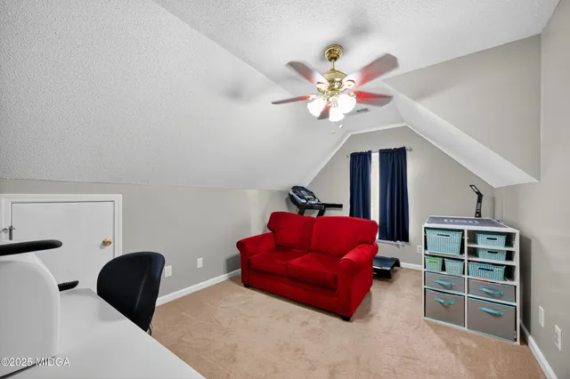 a view of a livingroom with workspace and a couch