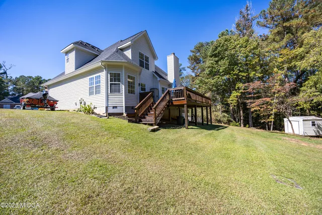 a view of a house with a yard and sitting area