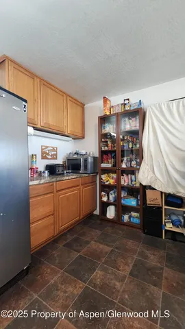 a kitchen with refrigerator and window