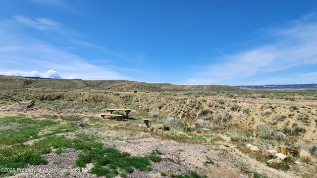 a view of a mountain in the distance in a field