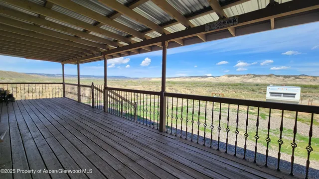a view of balcony with wooden floor