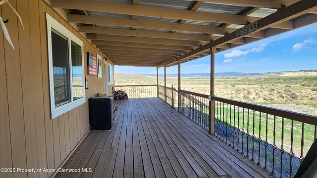 a view of a porch with wooden floor