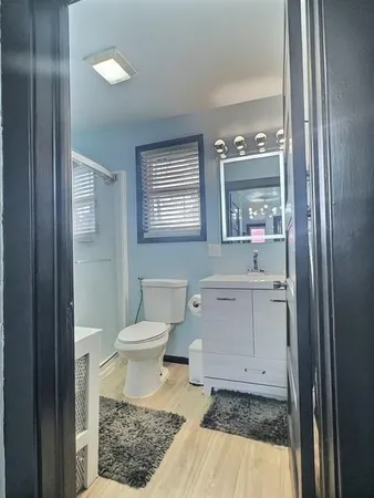 a bathroom with a sink toilet and shower