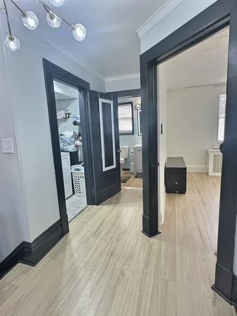 a hallway with wooden floor and furniture