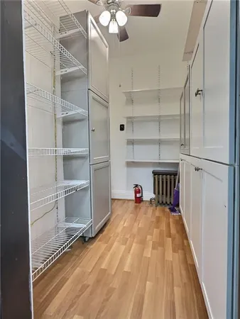 a view of a room with cabinets and wooden floor