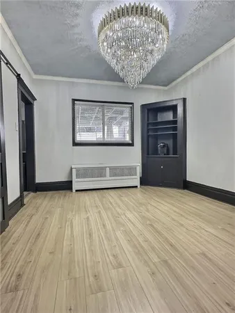 a view of an empty room and wooden floor