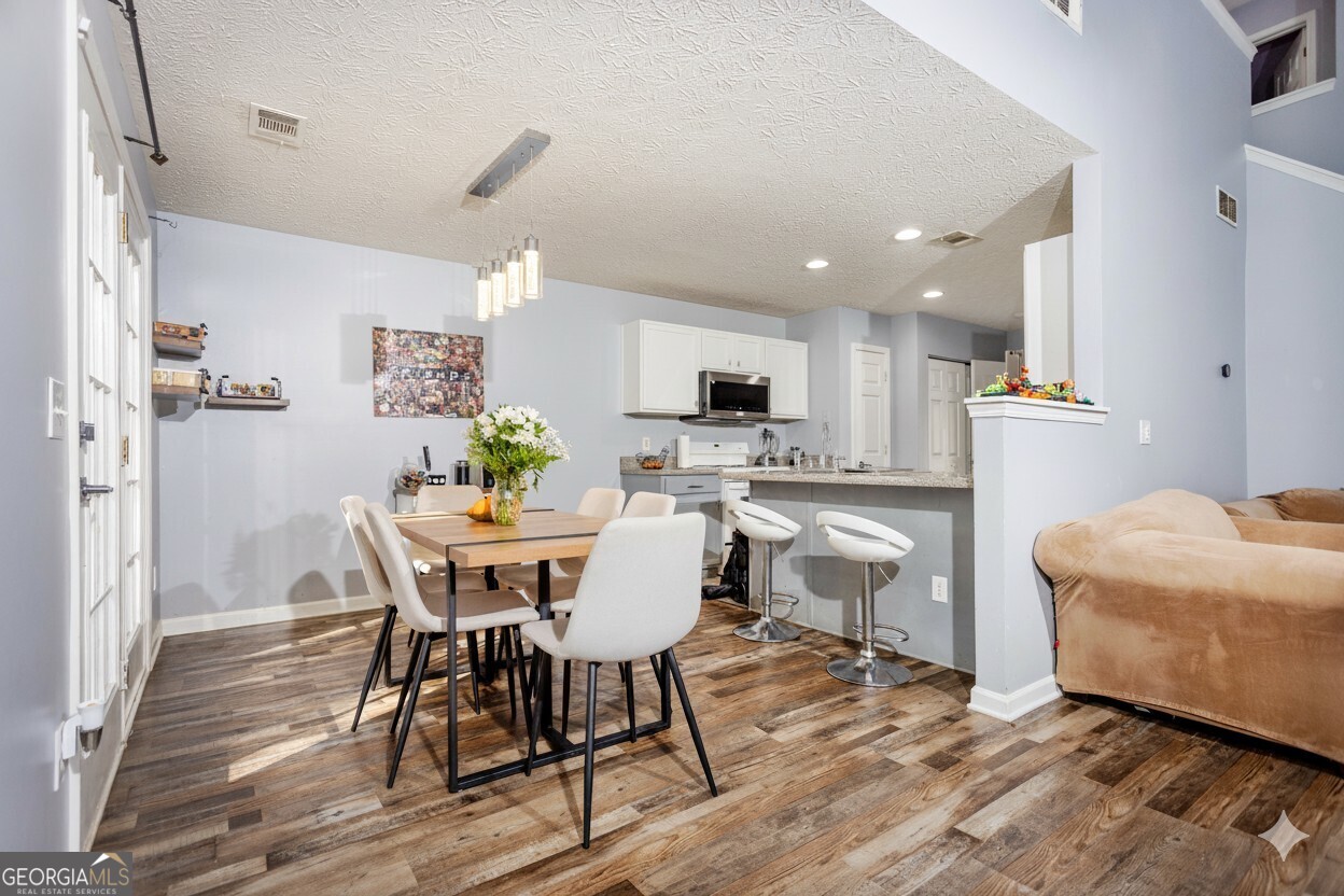 269 Silver Ridge Drive, Unit 269 Dallas, GA 30157 - Photo 11 of 34 a view of a dining room with furniture and wooden floor