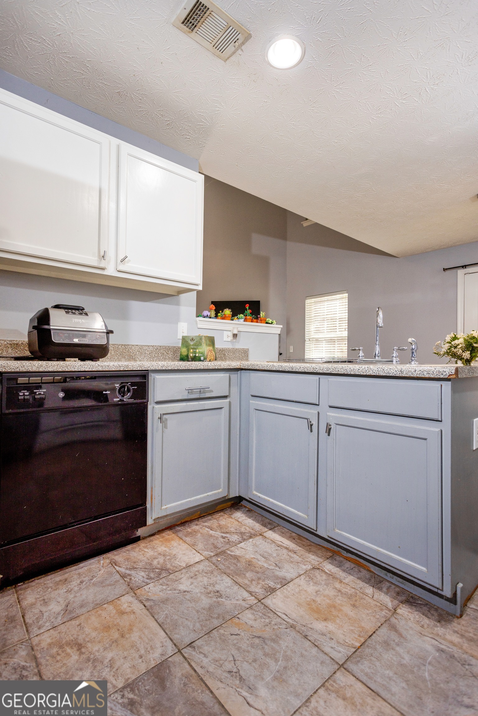269 Silver Ridge Drive, Unit 269 Dallas, GA 30157 - Photo 18 of 34 a kitchen with a sink stove and cabinets
