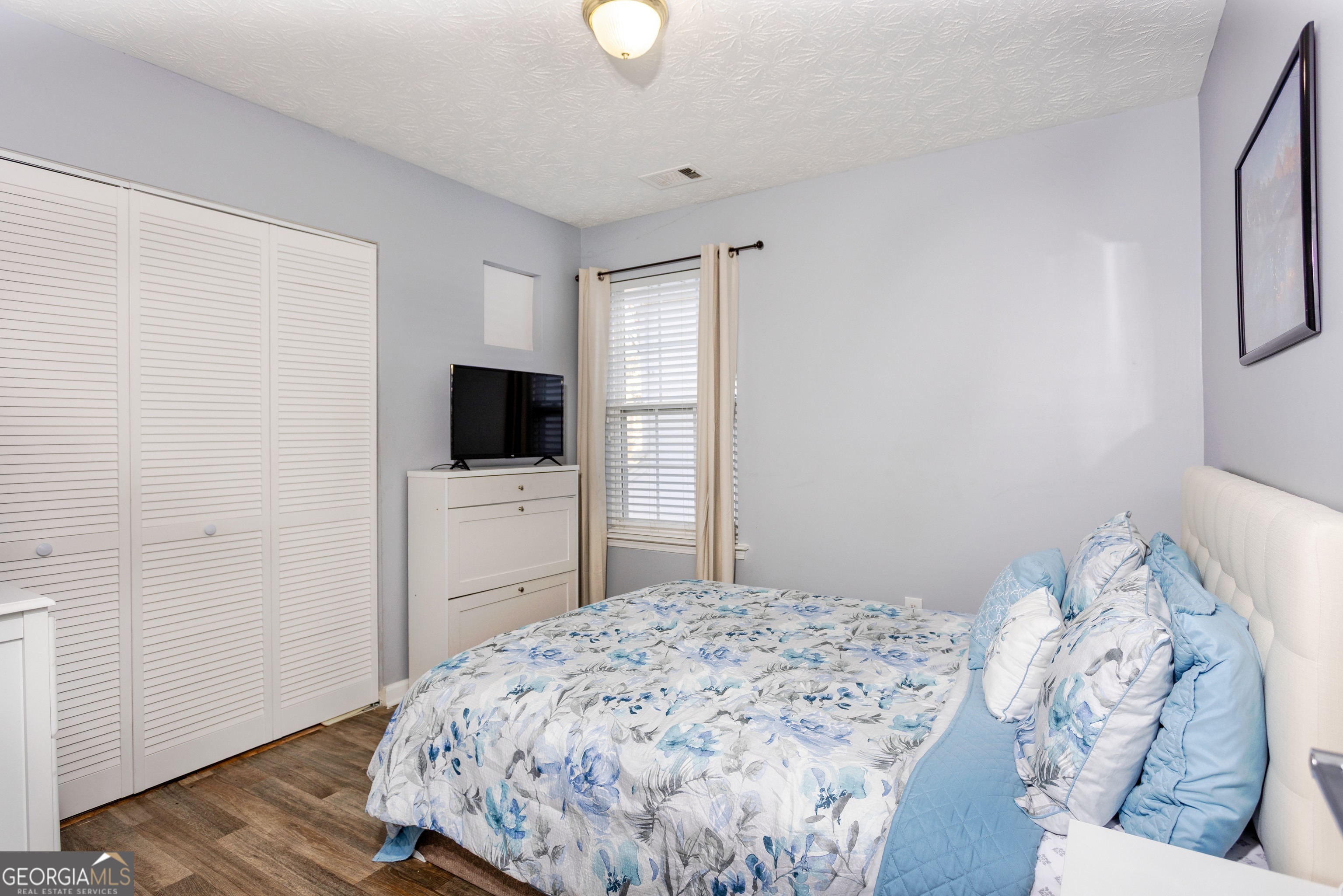 269 Silver Ridge Drive, Unit 269 Dallas, GA 30157 - Photo 28 of 34 a bedroom with a bed and a flat screen tv