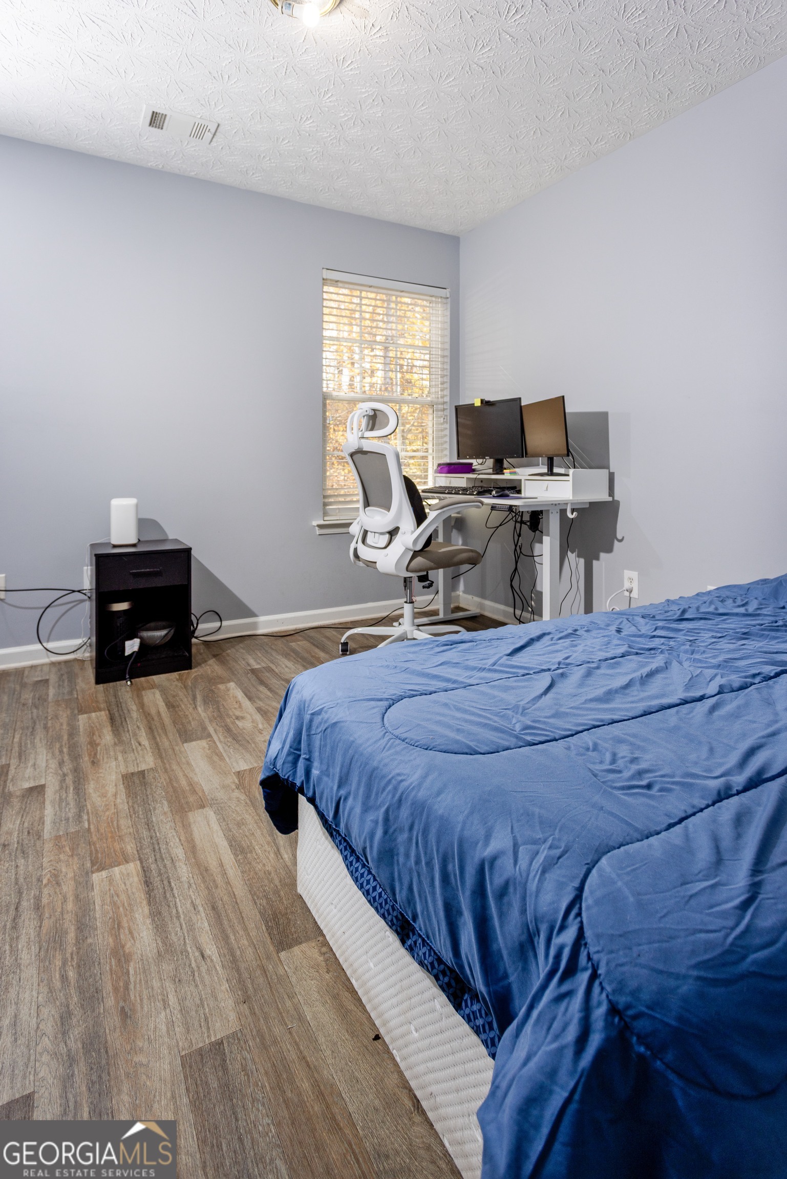 269 Silver Ridge Drive, Unit 269 Dallas, GA 30157 - Photo 29 of 34 a bed room with a bed and a chair