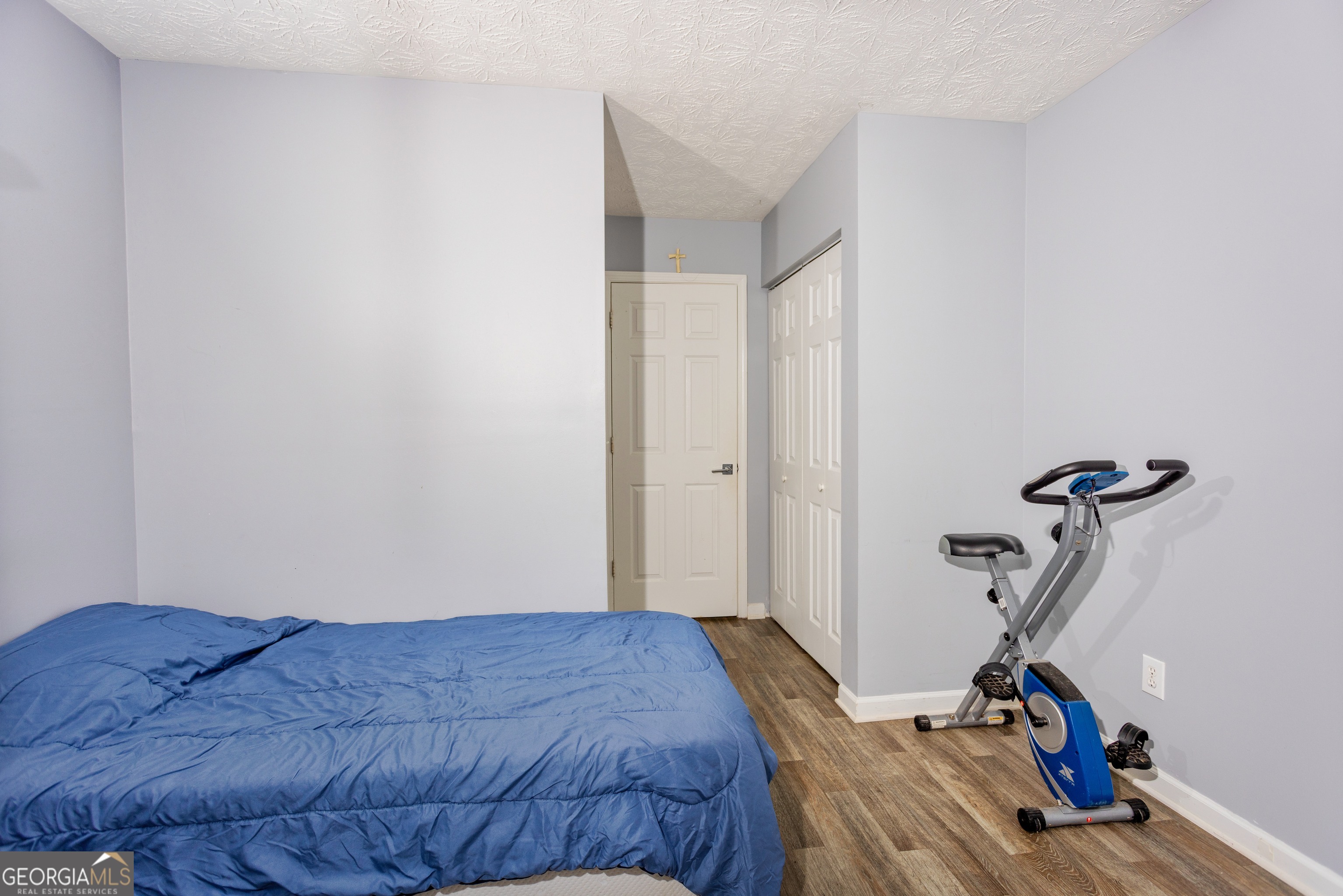 269 Silver Ridge Drive, Unit 269 Dallas, GA 30157 - Photo 30 of 34 a bedroom with a bed and a wooden floor