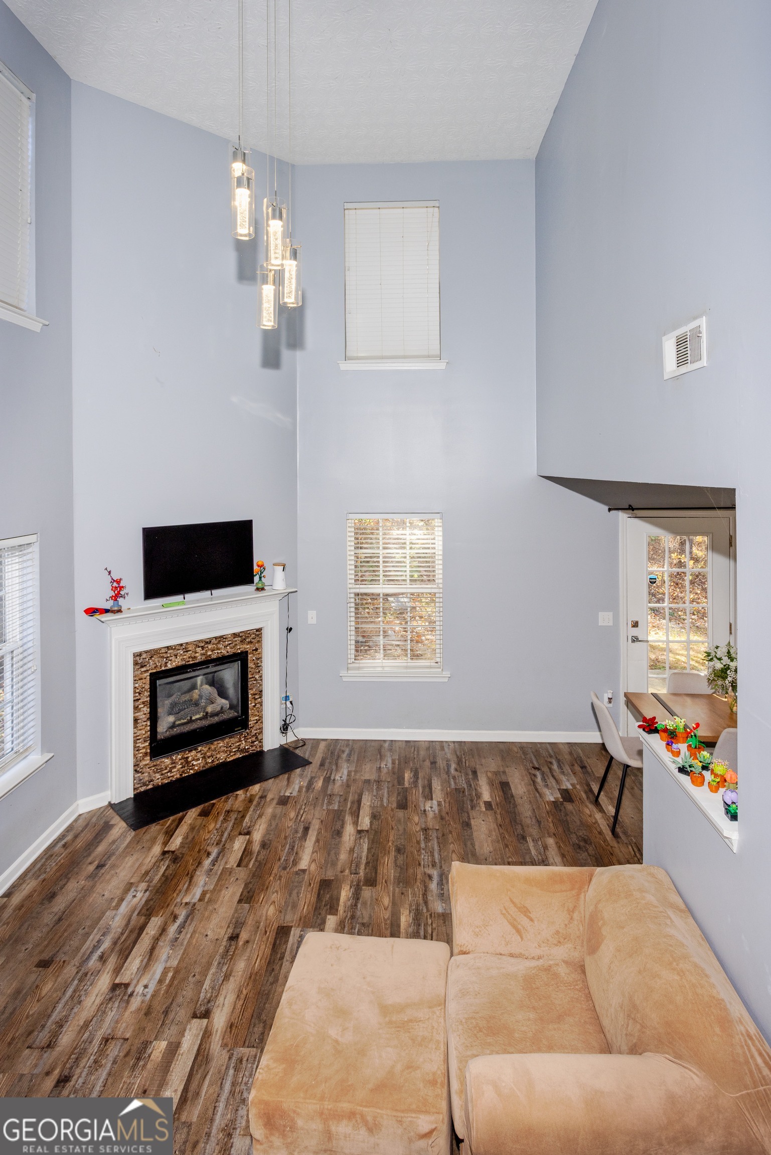 269 Silver Ridge Drive, Unit 269 Dallas, GA 30157 - Photo 34 of 34 a living room with furniture a fireplace and a flat screen tv