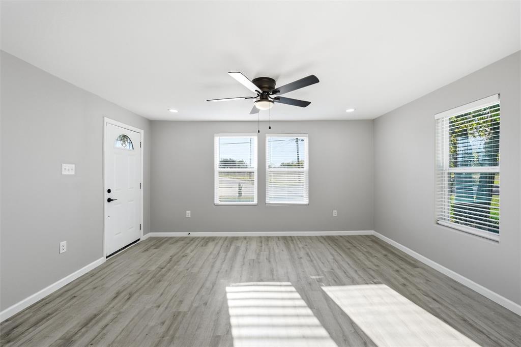 803 Garrison Street Waco, TX 76704 - Photo 4 of 16 wooden floor in an empty room with a window