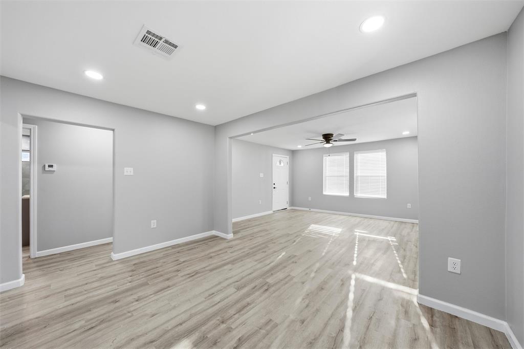 803 Garrison Street Waco, TX 76704 - Photo 5 of 16 a view of an empty room with wooden floor and a window