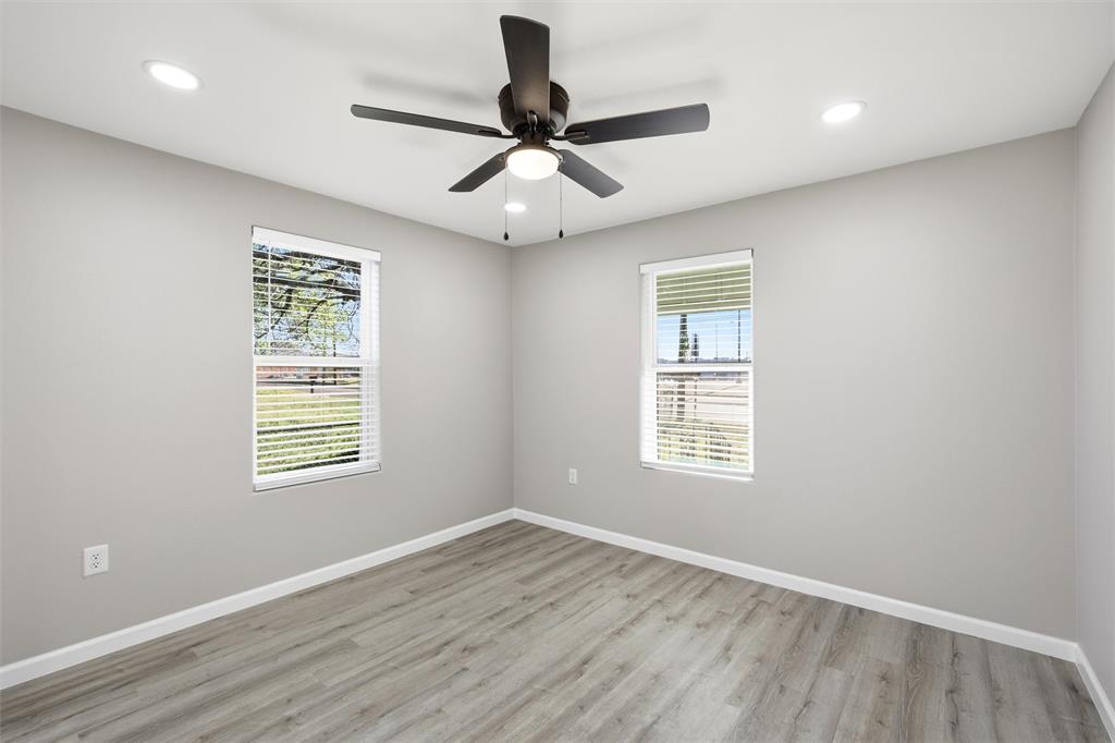 803 Garrison Street Waco, TX 76704 - Photo 9 of 16 a view of an empty room with wooden floor and a window