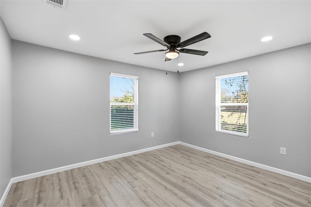803 Garrison Street Waco, TX 76704 - Photo 10 of 16 a view of an empty room with a window and wooden floor