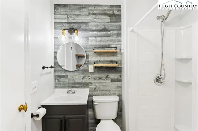 a bathroom with a sink toilet and mirror