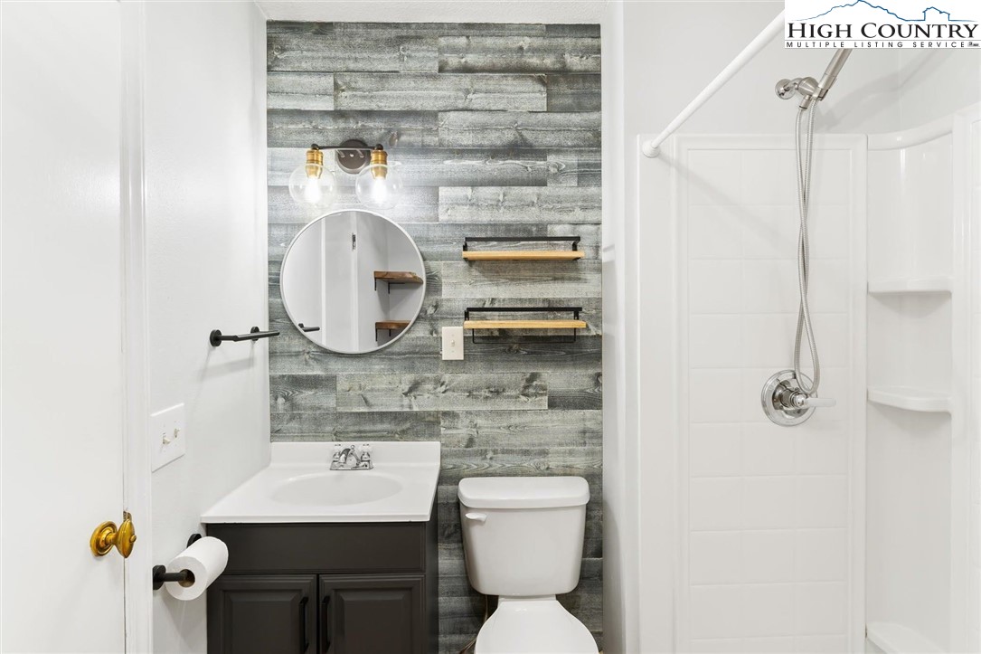 1028 Charter Hills Road Beech Mountain, NC 28604 - Photo 14 of 25 a bathroom with a sink toilet and mirror