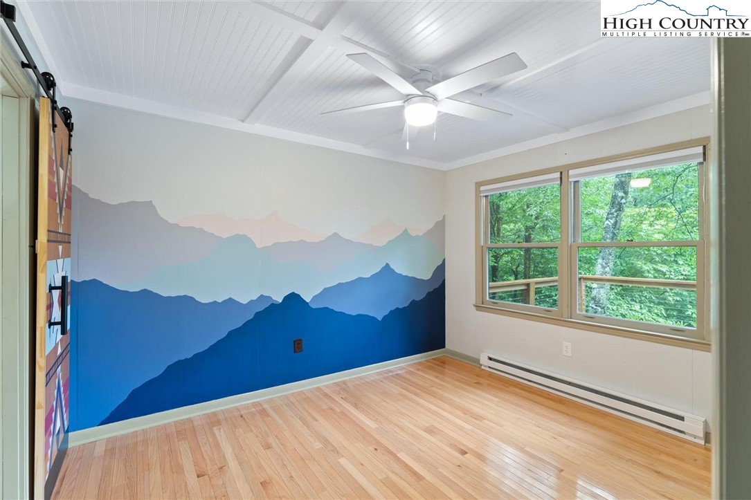1028 Charter Hills Road Beech Mountain, NC 28604 - Photo 17 of 25 a view of a big room with a bed and a window