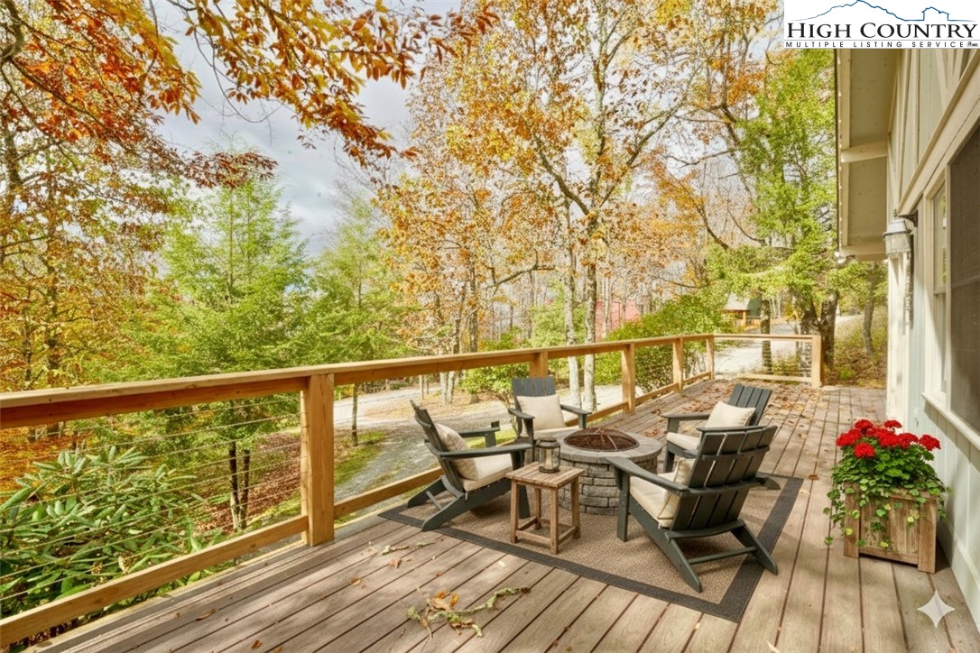 1028 Charter Hills Road Beech Mountain, NC 28604 - Photo 2 of 25 a balcony with couple of chairs and wooden floor