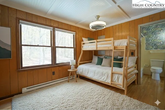 a bedroom with a bed and a large window