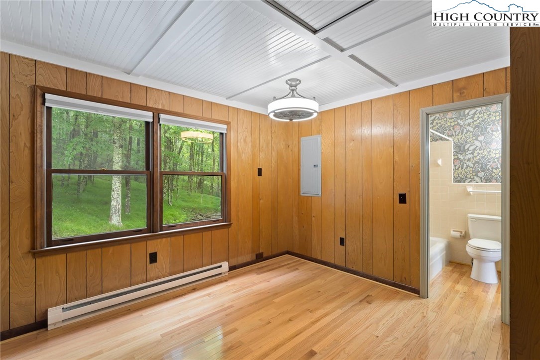 1028 Charter Hills Road Beech Mountain, NC 28604 - Photo 23 of 25 a view of empty room with wooden floor and fan