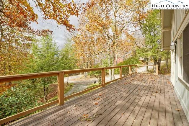 a view of balcony with wooden floor and fence