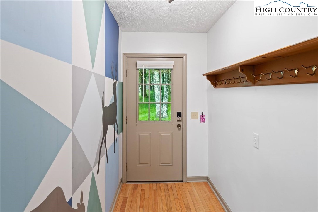 1028 Charter Hills Road Beech Mountain, NC 28604 - Photo 4 of 25 a view of a hallway with wooden floor and entryway