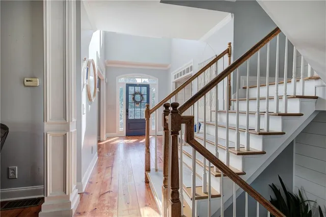a living room with furniture a fireplace and a chandelier