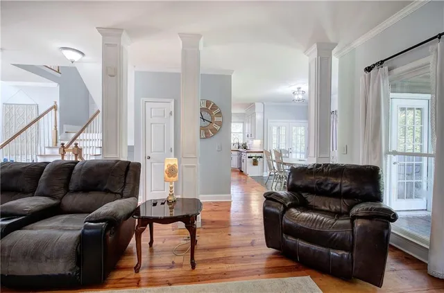 a living room with furniture and a wooden floor