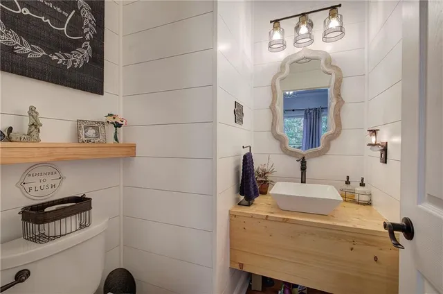 a kitchen with stainless steel appliances granite countertop a stove a sink and white cabinets