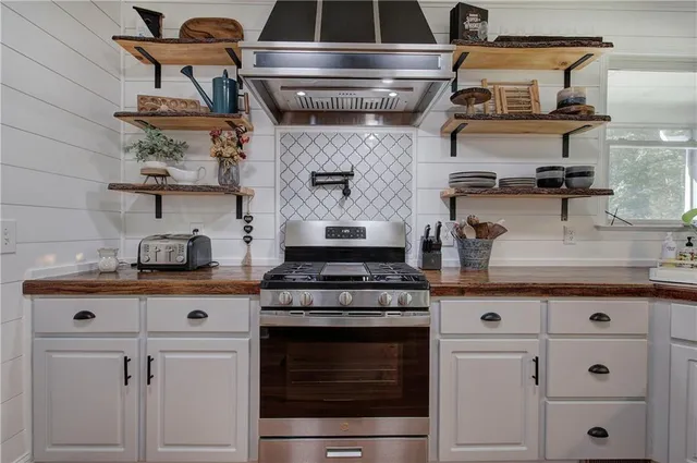 a bathroom with a sink and mirror with shower