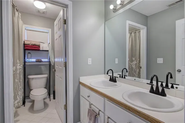 a view of a hallway and a livingroom with furniture