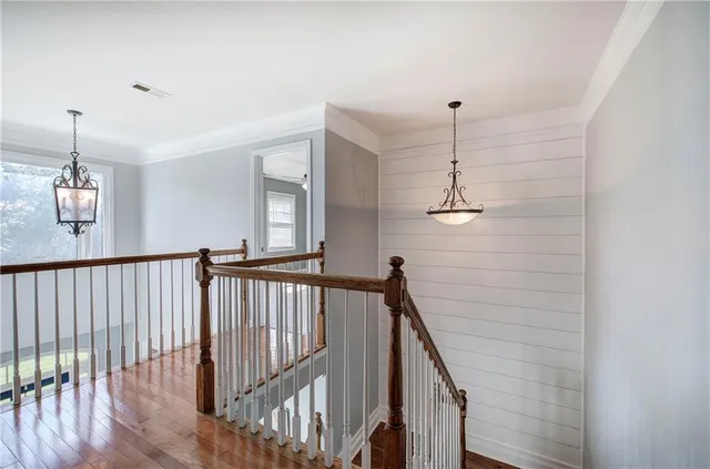 a view of a room with large windows and wooden floor