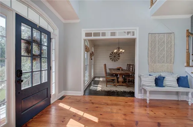 a view of a hallway with wooden floor and a fireplace