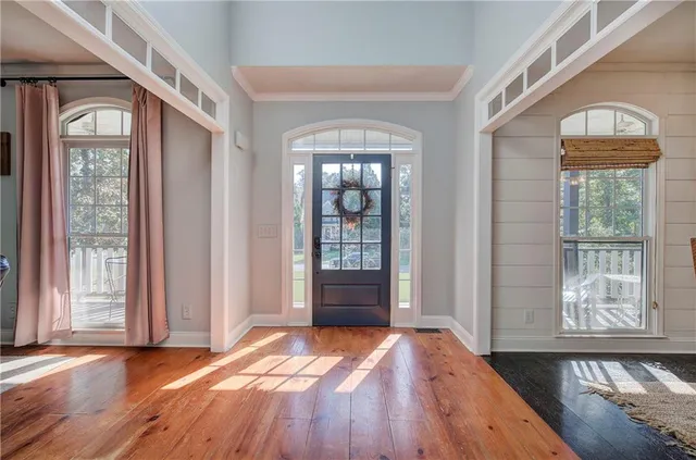 a view of a dining room with furniture wooden floor and chandelier