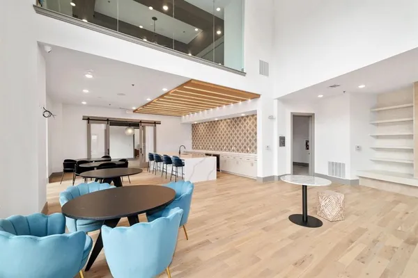 a kitchen with stainless steel appliances kitchen island granite countertop a table and chairs in it