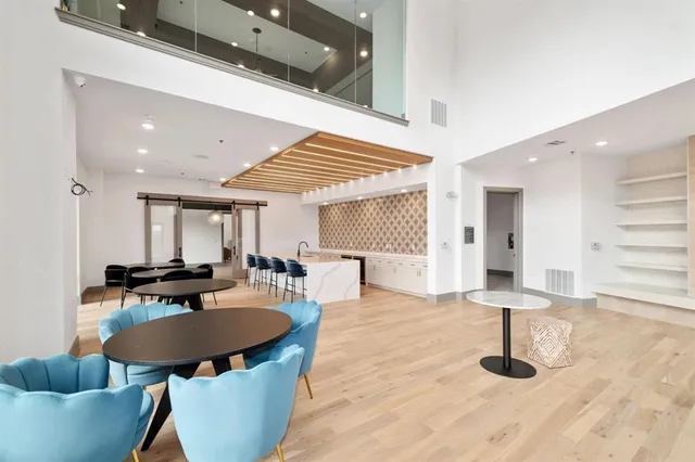 a kitchen with stainless steel appliances kitchen island granite countertop a table and chairs in it