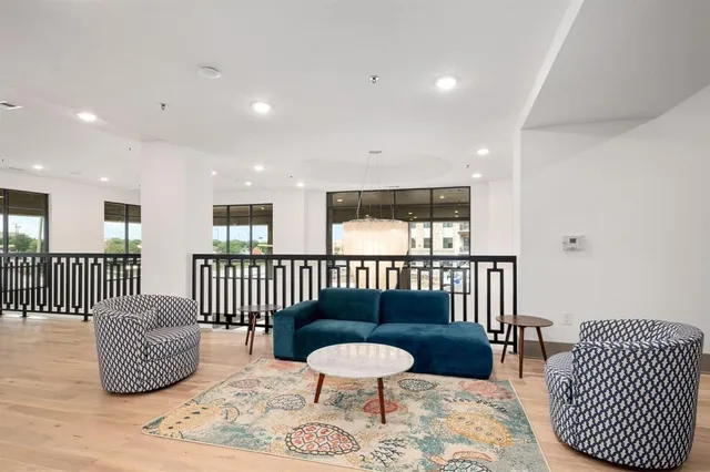 a bedroom with furniture and a rug