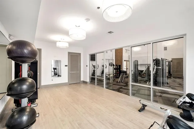 a room with gym equipment and a large window
