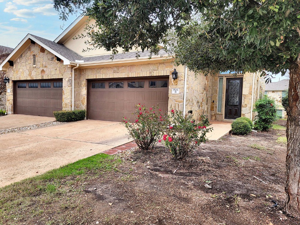 7508 Colina Vista Loop, Unit B Austin, TX 78750 - Photo 1 of 40 a front view of a house with a yard and a garage