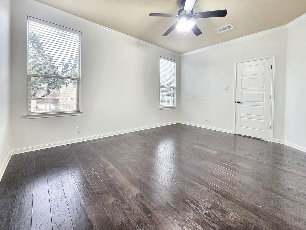 7508 Colina Vista Loop, Unit B Austin, TX 78750 - Photo 17 of 40 an empty room with wooden floor chandelier fan and windows