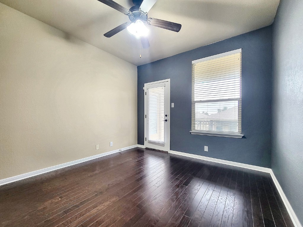 7508 Colina Vista Loop, Unit B Austin, TX 78750 - Photo 25 of 40 an empty room with wooden floor and windows