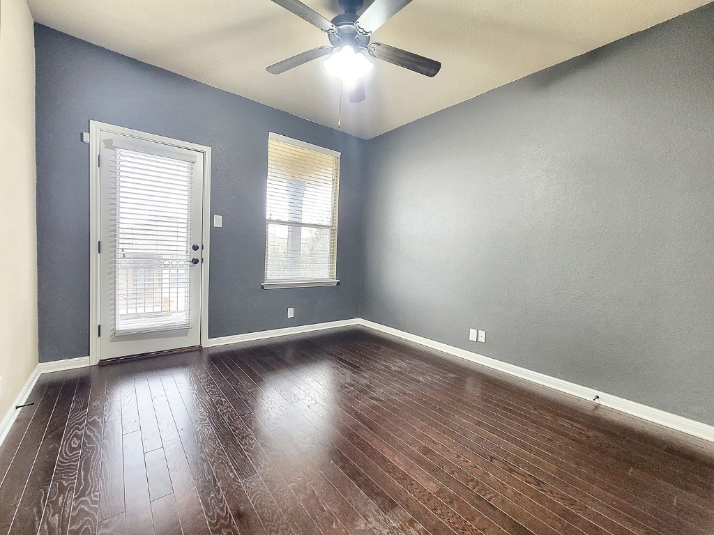 7508 Colina Vista Loop, Unit B Austin, TX 78750 - Photo 26 of 40 an empty room with wooden floor and windows