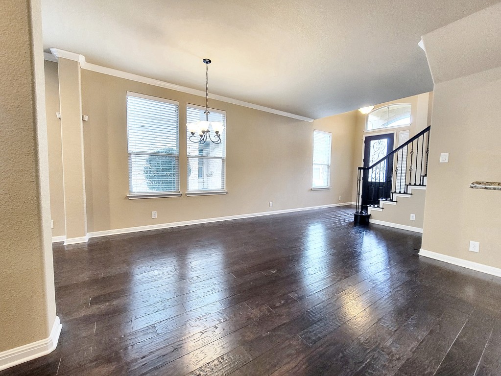 7508 Colina Vista Loop, Unit B Austin, TX 78750 - Photo 30 of 40 a view of an empty room with wooden floor and a window