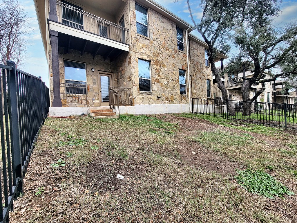 7508 Colina Vista Loop, Unit B Austin, TX 78750 - Photo 38 of 40 a view of a house with a yard