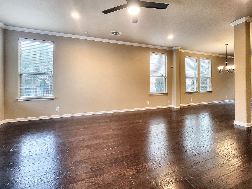 7508 Colina Vista Loop, Unit B Austin, TX 78750 - Photo 5 of 40 an empty room with wooden floor and windows