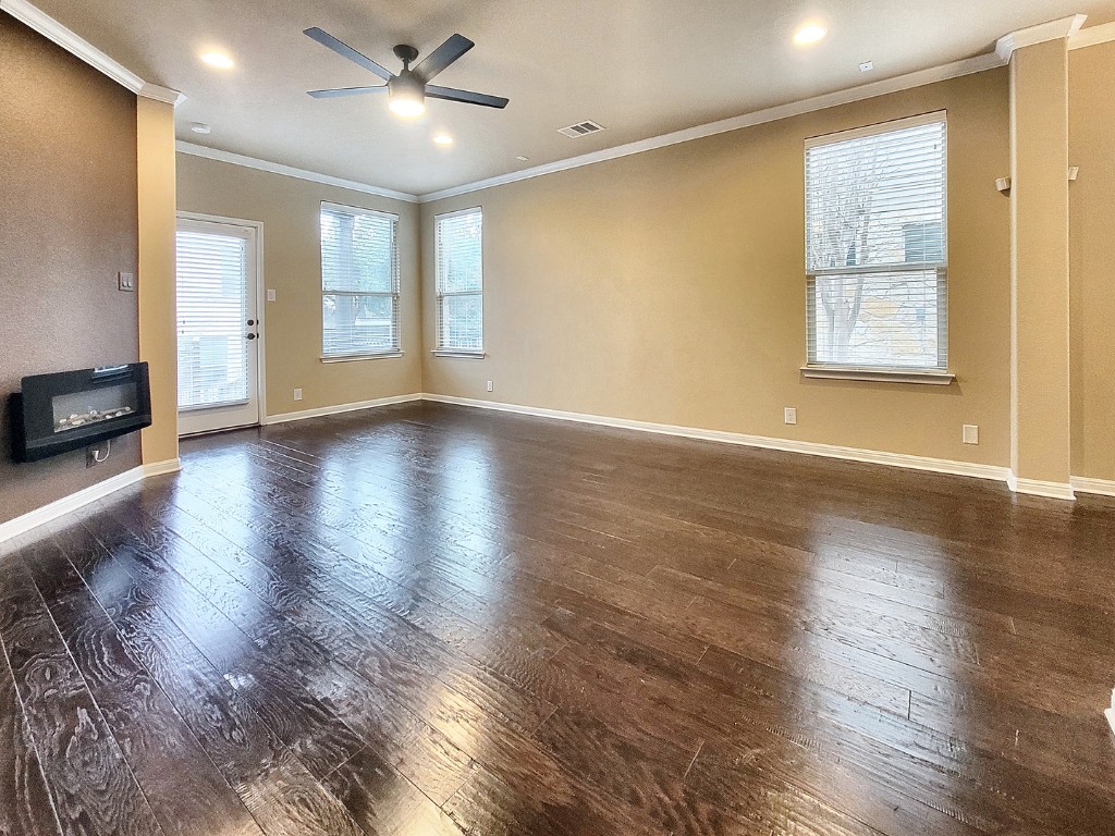 7508 Colina Vista Loop, Unit B Austin, TX 78750 - Photo 7 of 40 a view of an empty room with window and wooden floor